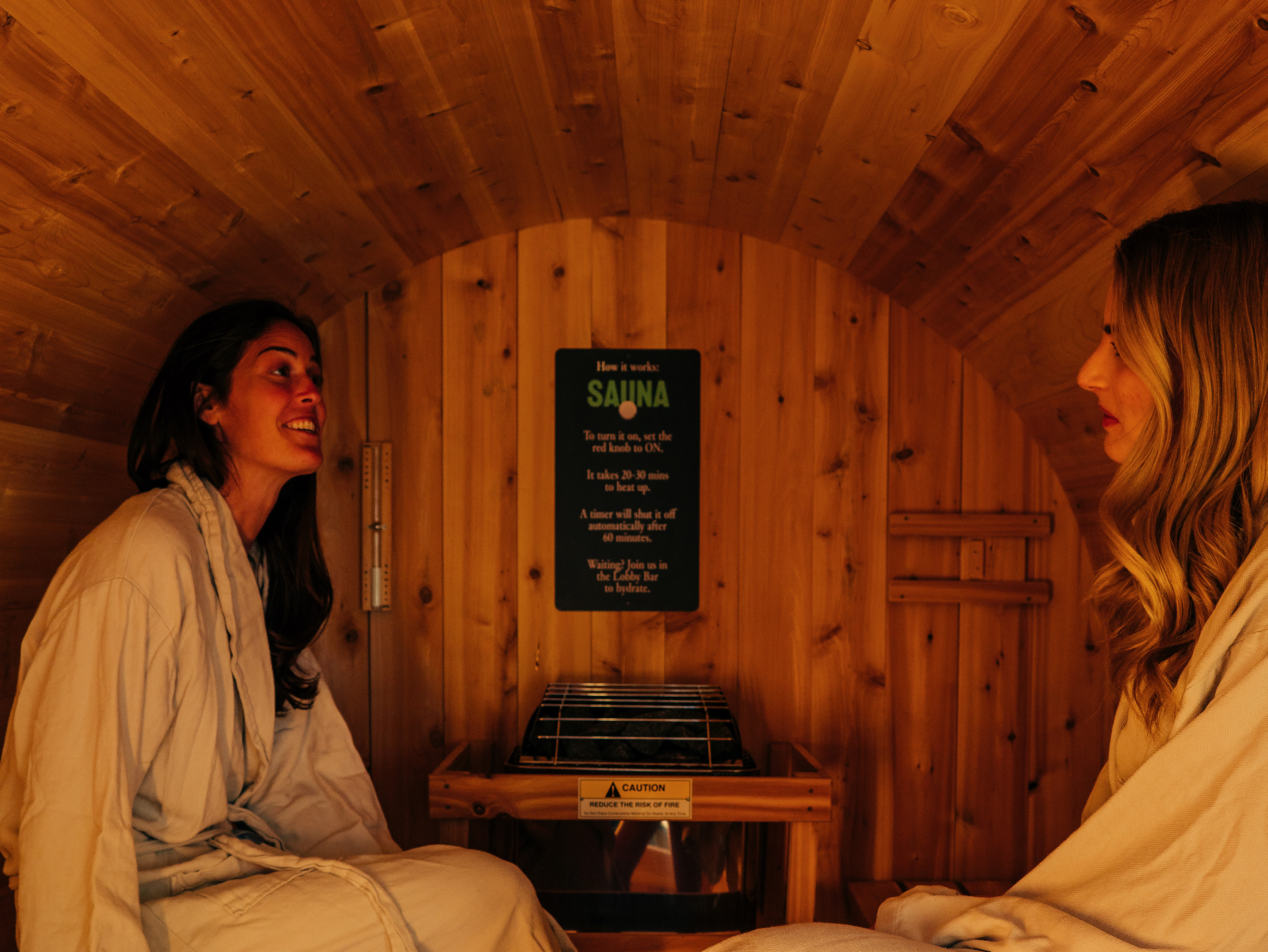 Two travellers sharing a quiet sauna experience